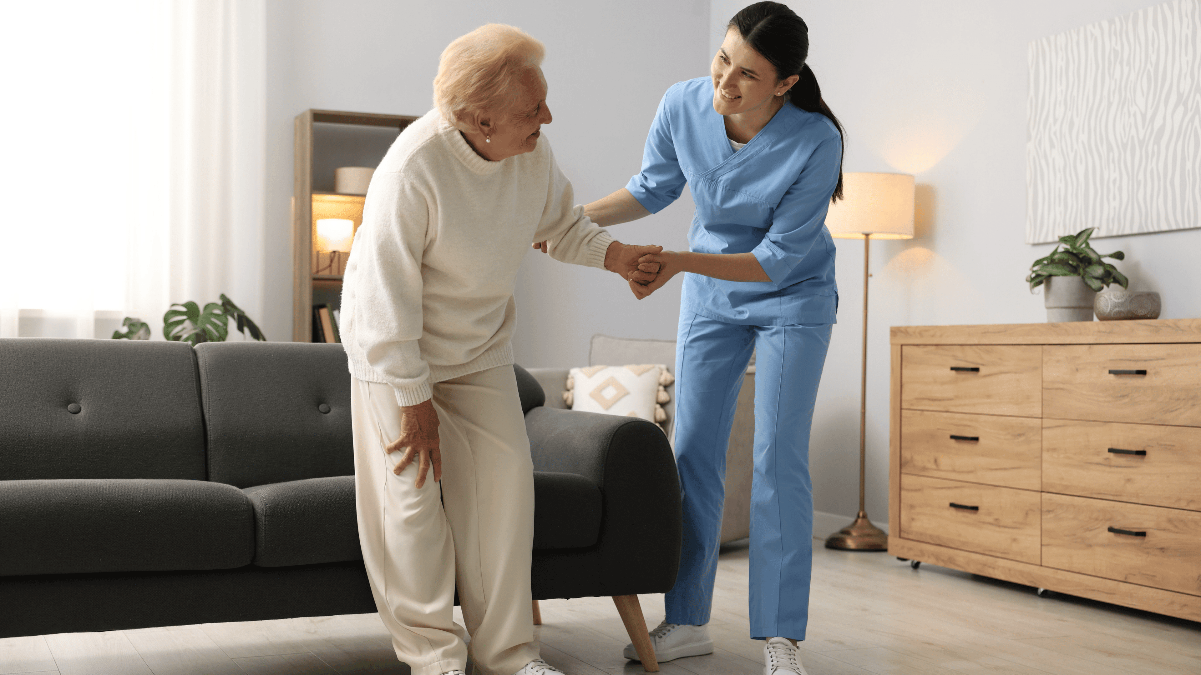 Home health aide assisting with mobility